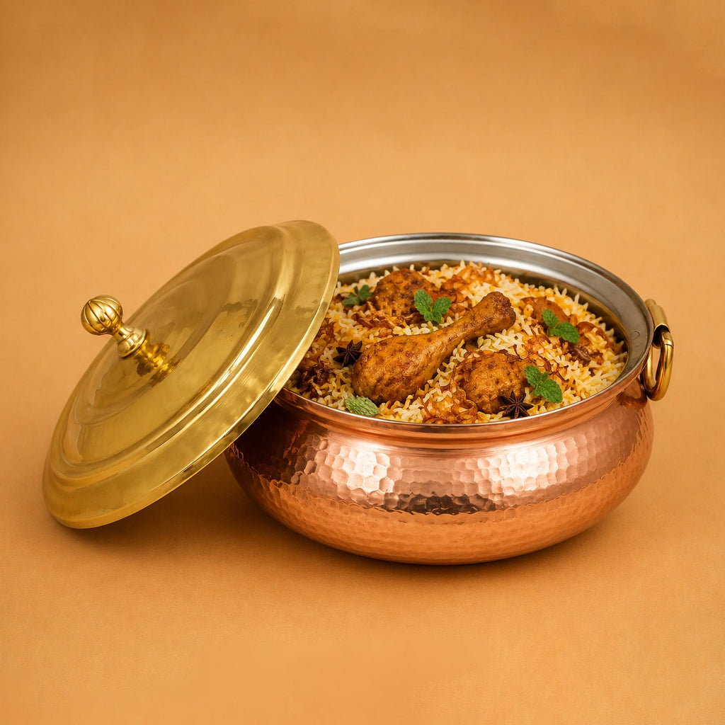 Copper dum biryani handi featuring a brass lid, designed for slow cooking and authentic Indian culinary traditions.