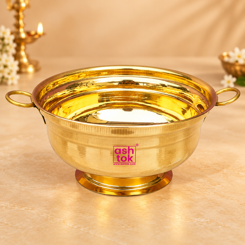Brass Gangal and Flower Pot decorative puja bowl displayed on a premium beige studio background, featuring a polished golden brass finish, wide round bowl, dual side handles, raised pedestal base and smooth reflective interior. Suitable for flower decoration, festive arrangements, puja use, water display, traditional ceremonies and decorative gifting.