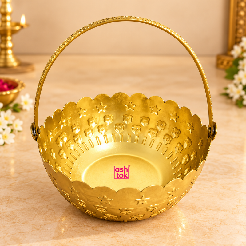 gift-basket-with-handle-main.webp	Gold coated flower gift basket with handle displayed on a premium beige studio background, featuring a round decorative bowl, scalloped rim, embossed floral and star motifs, polished golden finish and a tall curved carrying handle.