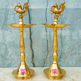 Premium brass peacock diya pair with elegant antique finish, suitable for pooja, home decoration, and festive celebrations.