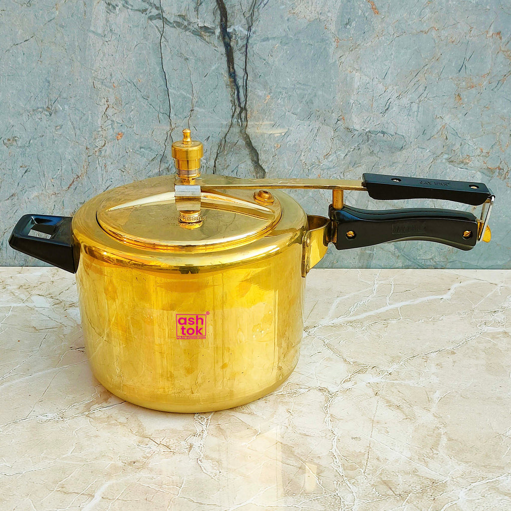 Traditional brass pressure cooker with 5 litre capacity, suitable for cooking rice, lentils, curries, and vegetables.
