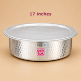 17 inch Aluminium Biryani Handi with Lid displayed in a clean product photograph against a warm beige background. The handi features a traditional wide circular cooking vessel design with a hammered silver aluminium exterior, smooth rounded base, broad rim and matching flat metal lid. The decorative hammered impressions create a textured surface across the body, while the spacious circular opening provides room for preparing layered rice dishes.