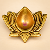 Top-angle view of an antique brass lotus diya showcasing its symmetrical flower-inspired shape, smooth teardrop-shaped central oil cavity and raised lotus petals with intricate grooved detailing. The traditional brass diya features a warm golden finish with darker accents in the engraved patterns, highlighting its decorative appearance for home temple worship, festive lighting and puja arrangements.