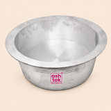 Front-facing product shot of a wide, open silver aluminum mixing bowl with a flared lip rim against a clean beige background. The bowl features fine horizontal line patterns etched around the exterior and a magenta Ashtok logo displayed in the center.