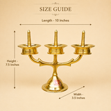 Size guide for Ashtok brass 3-face diya stand indicating 10 inches length, 7.5 inches height, and 3.5 inches width.