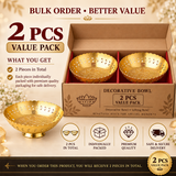 Product promotional graphic for the Ashtok Brass Decorative Bowl 2 Pcs Value Pack. An open cardboard shipping box displays two golden brass bowls with scalloped edges and cut-out side patterns. In the lower-left foreground, a single decorative brass bowl rests on a raised pedestal base with the red Ashtok logo on its interior. Text overlay reads "BULK ORDER • BETTER VALUE", "2 PCS VALUE PACK", and "DECORATIVE BOWL", along with four feature icons for quantity, individual packaging, quality, and delivery.