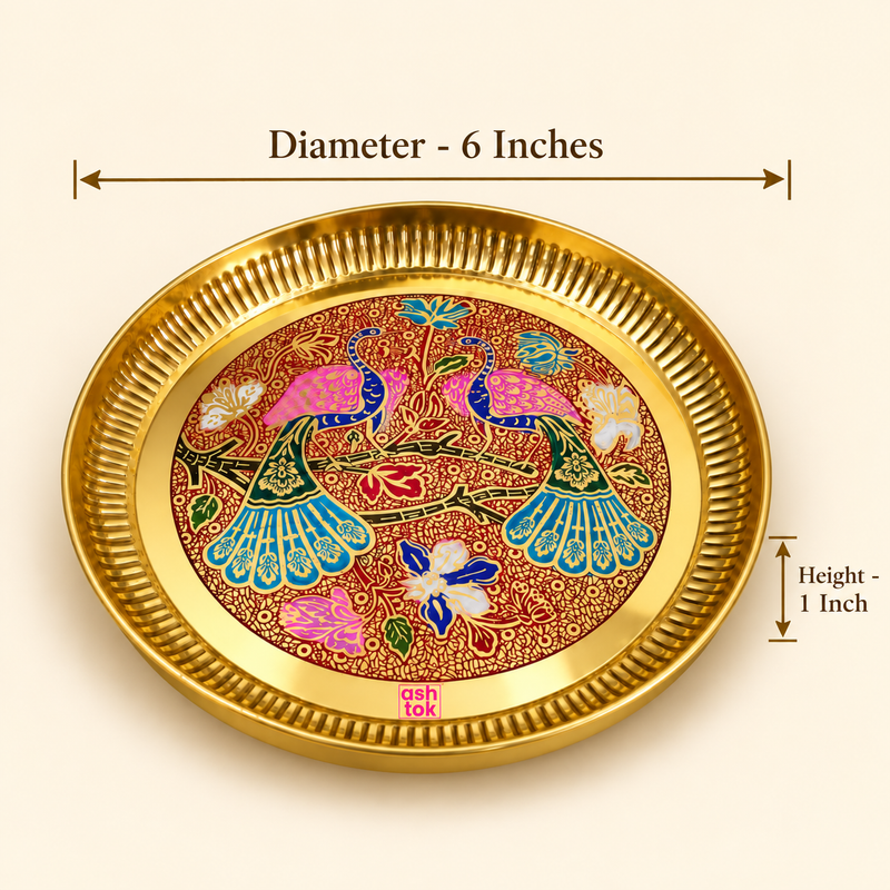 Product dimension diagram of the Ashtok round brass decorative tray against a warm studio background. Dimensional callout lines indicate a top outer diameter of 6 inches across the fluted rim and a side height of 1 inch. The center reveals intricate peacock Meenakari enamel artwork in pink, teal, blue, and red hues.