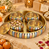 ASHTOK brass gift tray with 4 matching bowls styled in a festive setting, used for serving pistachios, dry fruits and sweets, showing elegant usage for celebrations, gifting and guest serving.