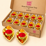 ASHTOK brass kumkum tray 10 pieces box set showing ten decorative leaf-shaped brass trays with two bowls for red kumkum and yellow haldi, neatly packed for festive gifting, wedding functions, return gifts and pooja use.