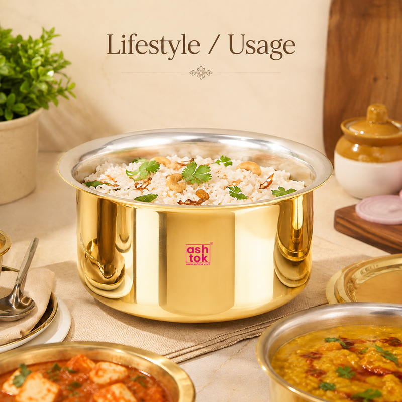Ashtok brass Patila filled with garnished rice on a dining setup alongside curry dishes.