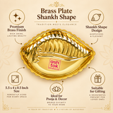 Features infographic image for the Ashtok brass plate shankh shape presented on a premium beige background with elegant design elements and feature callouts. The central product is a polished brass shankh-shaped plate with a rich golden finish, embossed inner detailing, scalloped border and the original pink Ashtok logo in the center. Around the product, the image highlights important selling points such as premium brass finish, traditional shankh shape design, approximate size of 5.5 x 4 x 0.5 inch, ideal 