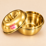 Detailed close-up view of the Ashtok Brass Sindoor Box shown open on a clean warm beige studio background to display the smooth polished brass interior, rounded storage bowl, rolled rim, matching dome-shaped lid and small turned brass knob. The lid is positioned beside the open container so customers can clearly see both the inside and outside construction, while the original pink Ashtok logo remains visible on the glossy golden lid. The rich polished brass finish and clean curved design make this compact 2