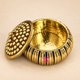 ASHTOK brass sindoor kum kum box with ribbed round body, decorative beaded lid and polished brass finish, displayed on a clean warm beige background for pooja, gifting and festive use.
