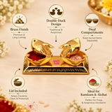 Image of Ashtok brass sindoor box in double duck design made from polished brass, showing dual compartments for kumkum and akshat, lid included, traditional design, and suitability for pooja and auspicious occasions, displayed on a clean beige background.