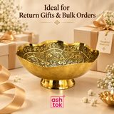 Ashtok Brass Turkish Bowl presented in a premium return gifting and bulk order setting with decorative beige gift boxes, ribbons, flowers and festive styling, highlighting the bowl as an elegant traditional gift item for weddings, festive functions, housewarming ceremonies, family celebrations and event giveaways. The golden brass bowl features a scalloped rim, ornate floral engraved interior and polished pedestal base, creating a refined handcrafted appearance suitable for gifting individually or in larger