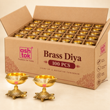 Pack of 100 brass diyas with turtle bases showcased in a bulk packaging box, designed for wholesalers, festive gifting, event distribution, pooja return gifts, and large-quantity orders.