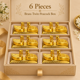 Six piece gift set image of the brass twin peacock box arranged neatly inside a premium beige presentation box with cushioned compartments. Each unit features the same polished golden brass finish, twin peacock-shaped compartments, decorative embossed design and elegant rectangular base, creating a luxurious and coordinated gift pack appearance. This quantity option is ideal for wedding return gifts, pooja favors, festive gifting, family celebrations, traditional gift hampers and boutique gifting requiremen