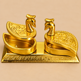 Detailed close-up image of the brass twin peacock box shown with both lids open to reveal the inner storage compartments. The image highlights the inside cavity of each compartment, the smooth brass interior, the shape of the hinged or lift-off peacock lids, the embossed ornamental detailing on top and the polished golden finish across the full piece. This close-up allows customers to see the functional storage aspect of the product more clearly, making it easier to understand how the twin compartments can 