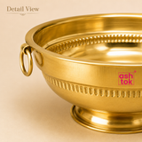 Close-up detail view of Ashtok brass urli bowl showcasing its smooth brushed metallic finish, side ring handle attachment, and fine ribbed embossing.