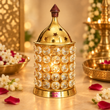 ASHTOK Crystal Diya Brass styled in a festive lifestyle setting with warm ambient lighting, flowers, brass decor and glowing diya elements in the background. The product is placed prominently in the center, showing how it can be used during pooja, festive celebrations, home decoration and special occasions. The image creates a rich traditional atmosphere with floral accents and a soft golden glow, highlighting the elegant beauty of the brass and crystal design in real-life usage.
