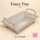 Ashtok German silver fancy tray in 15 x 11 inch size on a soft beige background, featuring a medium-sized rectangular decorative tray with intricate filigree metalwork, glossy silver finish, elevated bead handles, detailed edge craftsmanship, and a mirrored serving surface, suitable for festive serving, pooja gift presentation, wedding return gifts, dry fruit arrangement, and home display purposes.