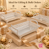 Feature-focused product image of the Ashtok German silver fancy tray on a beige background, clearly showing the tray’s premium filigree side design, polished metallic finish, strong rectangular frame, elegant beaded handles, elevated feet for added sophistication, and flat reflective base, emphasizing its decorative value, refined detailing, and suitability as a stylish serving tray and premium gift item.