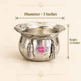 Size guide image of the ASHTOK German Silver handi and sweet bowl showing a diameter of 3 inches and height of 2.5 inches. The product is displayed on a clean beige background with measurement arrows while preserving its hammered silver-finish body, scalloped rim, twisted rope detailing, decorative tassels and pink ASHTOK logo, helping customers understand the compact serving size before purchase.