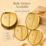 Ashtok golden metal leaf-shaped tray featuring embossed leaf vein texture and a high-shine polished finish. Bulk orders Available .