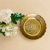 ASHTOK gold-tone floral serving plate with embossed flower design and scalloped edge displayed on a beige background with white flowers