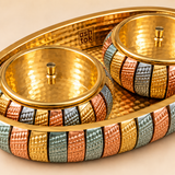 Close-up of ASHTOK serving tray set showing hammered finish, multitone decorative border and lidded bowls