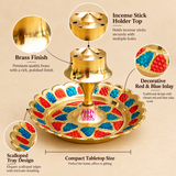 Detailed features image of a Brass Incense Stick Holder highlighting its polished golden brass finish, multiple incense stick holding holes, raised central pedestal, decorative red and blue Meenakari-style inlay and beautifully scalloped circular tray. The traditional brass agarbatti stand measures 3.5 inches in diameter and 2 inches in height. Its decorative tray design complements daily puja rituals, home mandir arrangements, spiritual spaces, religious ceremonies and traditional Indian home decoration.