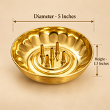 Size guide of a traditional brass agarbatti stand with five upright incense stick holders, a round polished golden bowl and decorative scalloped inner walls. The incense holder measures 5 inches in diameter and 1.5 inches in height, featuring a compact design with an integrated ash-catching bowl suitable for daily pooja, home temples, religious rituals and decorative incense arrangements.