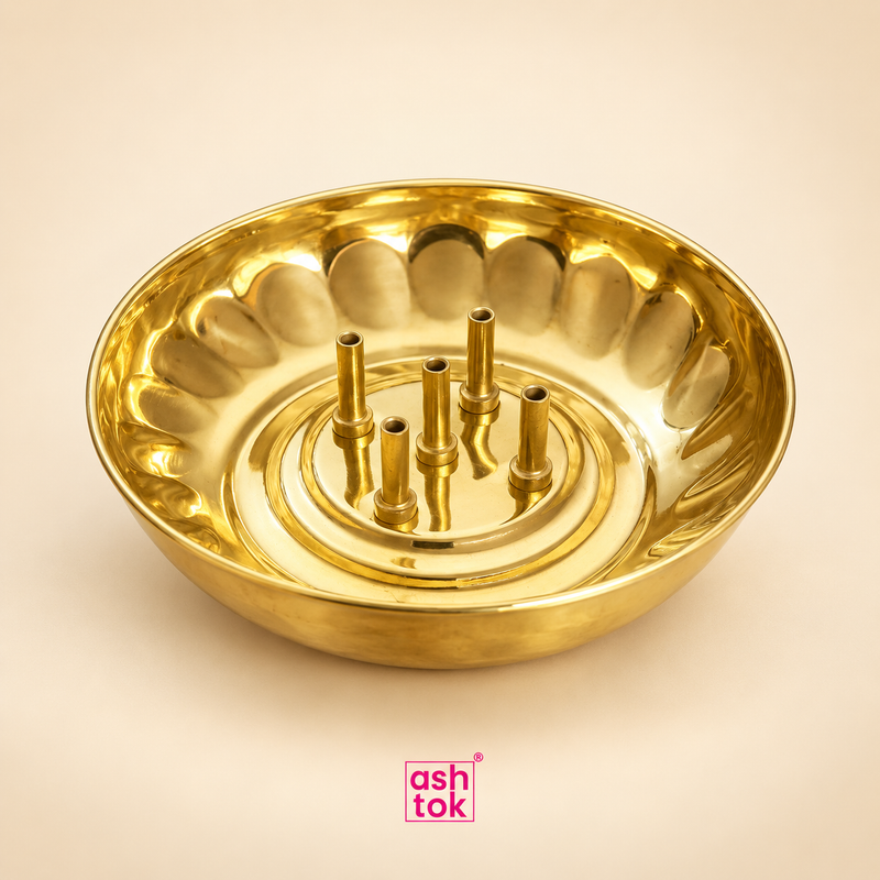 Polished brass agarbatti stand with round ash-catching tray, five incense stick holders and smooth golden finish, shown as a clean product image on a plain beige background for product display and online listing.