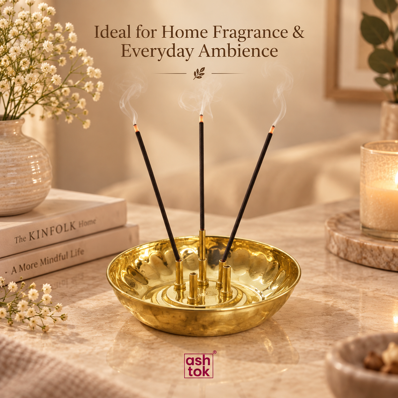 Brass agarbatti stand placed in a warm home setting with burning incense sticks, styled with books, flowers and soft candlelight, showing its use for home fragrance, everyday ambience and decorative aromatic use rather than traditional pooja-focused use.