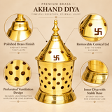 Brass Akhand Diya features infographic highlighting its polished golden brass construction, removable conical dome with traditional Swastik cutout symbols, multiple round ventilation openings, inner brass diya with central wick holder, and sturdy stepped pedestal base. The decorative lantern-style enclosure surrounds the inner oil lamp while allowing light to shine through its perforated surfaces. This traditional 7-inch brass Akhand Deep is suitable for home mandirs, daily pooja arrangements, festive relig