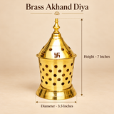 Brass Akhand Diya measurement guide showing an overall height of 7 inches and a diameter of 3.5 inches. The golden brass pooja lamp features a decorative conical lid with traditional Swastik cutouts, circular ventilation holes, a pointed ornamental finial, perforated cylindrical body, and a stable stepped base. This size reference helps customers understand the dimensions of the traditional Akhand Jyoti brass oil lamp for home temples, Navratri pooja, Diwali celebrations, and daily devotional worship.