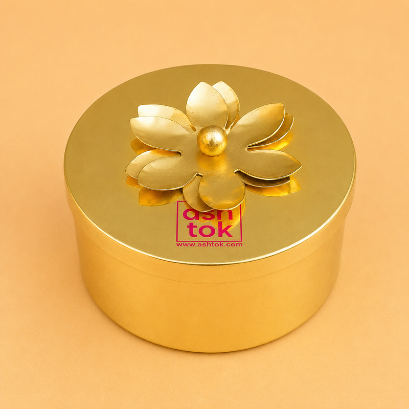 "Luxury round brass color gift box with floral lid for dry fruits, chocolates, cookies, sweets, and festive hampers."