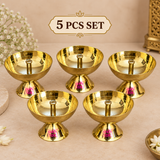 Set of 5 traditional brass diyas arranged neatly on a premium beige background, each featuring a polished golden bowl, central wick holder and pedestal base, suitable for Diwali decoration, puja ceremonies, festive gifting and home worship.