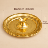 Size guide of a traditional brass diya with attached pooja plate showing a diameter of 13 inches and an overall height of 2.5 inches. The golden brass thali features a decorative beaded outer rim, fluted border, engraved star-shaped patterns and a central raised brass diya cup with a small pouring spout. The image highlights the dimensions and traditional design of this brass pooja accessory for daily worship, religious rituals and festive celebrations.