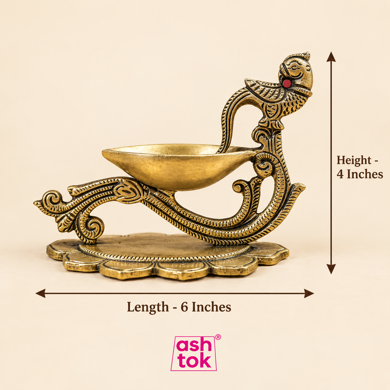 Brass diya with peacock handle shown with size guide, measuring 4 inches in height and 6 inches in length, suitable for pooja and festive use.