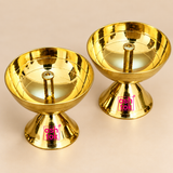 Detailed close-up of traditional brass diya showing the smooth polished oil bowl, raised central wick holder, reflective golden interior and sturdy pedestal base, highlighting the clean finish and traditional construction of the pooja lamp.