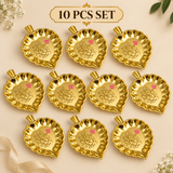 Set of 10 brass Ganesh leaf trays displayed in an organized gifting arrangement, featuring matching decorative leaf shapes and polished golden finish for weddings, religious events, festive gifting and bulk orders.