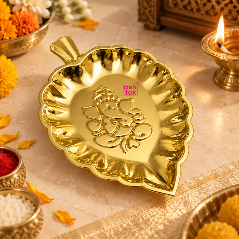 Brass Ganesh leaf tray displayed in a traditional puja setting with diya, flowers, kumkum and festive decor, showing its use for offerings, religious ceremonies, home temple decoration and auspicious festive occasions.