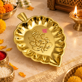 Brass Ganesh leaf tray displayed in a traditional puja setting with diya, flowers, kumkum and festive decor, showing its use for offerings, religious ceremonies, home temple decoration and auspicious festive occasions.