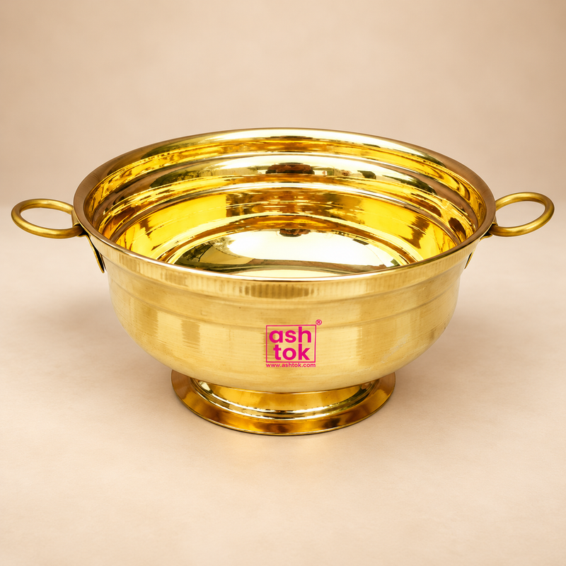 Brass Gangal and Flower Pot with a polished golden finish, wide round bowl, two circular side handles and stable pedestal base, professionally presented on a premium beige studio background for puja, floral decoration and traditional home decor.
