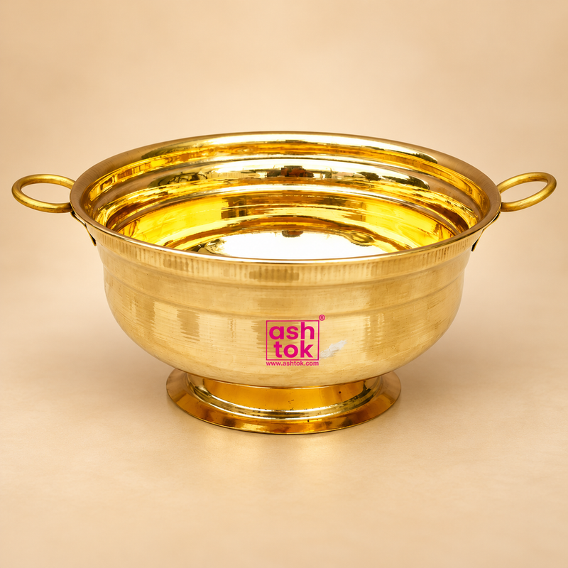 Brass Gangalam 6 inch bowl in polished brass finish with side handles on a beige background
