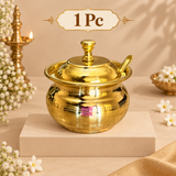 One piece brass ghee pot with matching lid and serving spoon displayed individually in a clean festive beige presentation. The polished golden container features a rounded traditional handi-style body, wide rim, fitted domed lid with decorative knob and a matching brass spoon resting neatly at the side. This 1 piece option is suitable for personal kitchen use, everyday ghee serving, festive dining, pooja use, wedding gifting, housewarming presents and traditional Indian gift hampers.