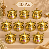 Set of 10 brass ghee pots with matching lids and spoons displayed together in an organized beige gifting arrangement. Each polished golden pot features a rounded handi-style serving body, wide rim, decorative fitted lid and matching brass serving spoon. This 10 piece pack is suitable for wedding return gifts, festive giveaways, housewarming ceremonies, religious functions, family events, corporate traditional gifting and larger gift distribution requirements.