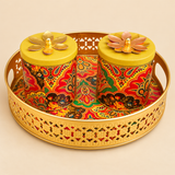 Front view of brass gift tray set with two matching lidded bowls, featuring colourful paisley print and floral lid accents on a beige background