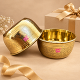 Set of 2 handcrafted brass hammered bowls presented as an elegant gifting option with premium gift packaging, featuring engraved floral detailing, polished golden finish and decorative rims, suitable for festive gifting, housewarming, return gifts and special occasions.
